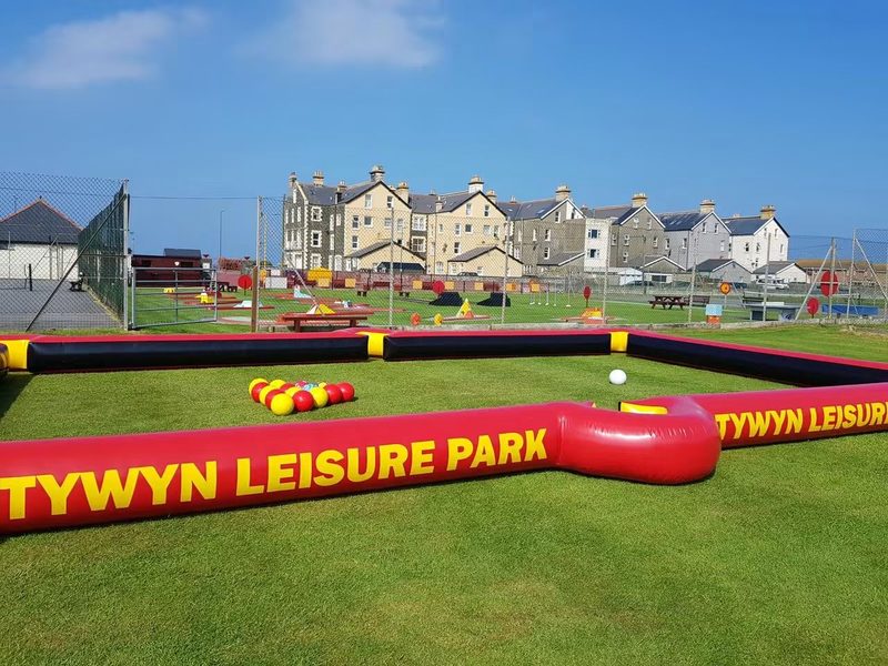 The giant inflatable football pool on the lawn, with the crazy golf course and seafront houses behind