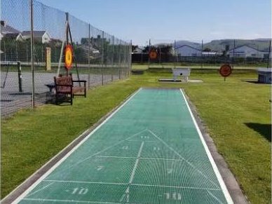 The green outdoor shuffleboard court